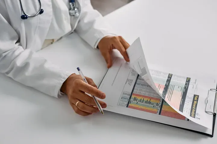 Physician reviewing weight-loss lab report with patient